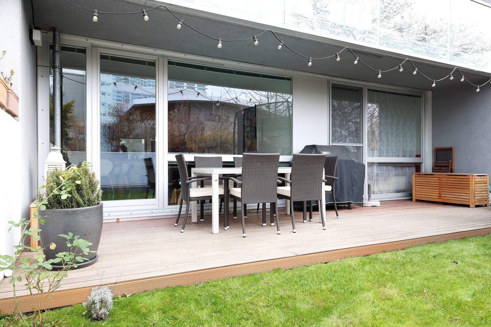 Terrace with wooden decking and private garden lawn